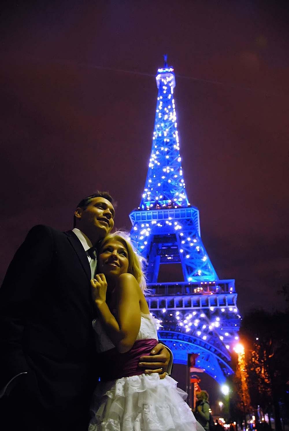 Weddings in and Around Paris 11 Bride and groom with twinkling blue Eiffel Tower in background, Paris, France