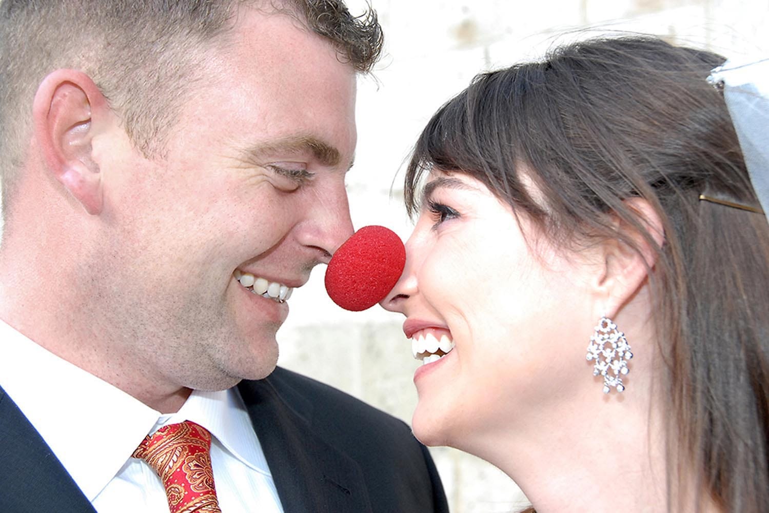 Weddings in and Around Paris 89 Close-up portrait of bride and groom with clown's nose