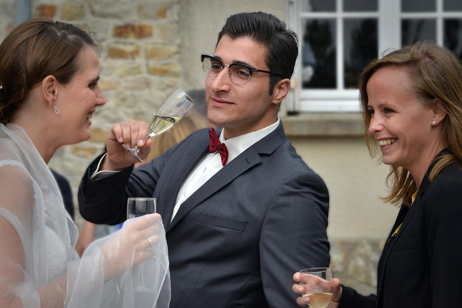 Man drinking champagne at wedding reception