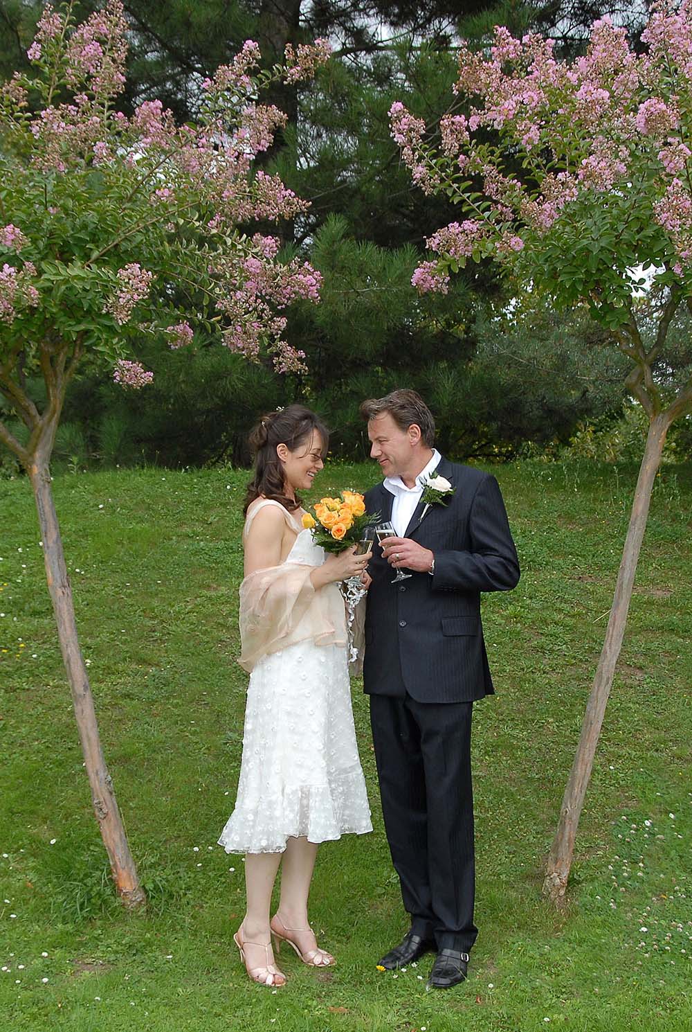 Weddings in and Around Paris 41 Married couple holding flowers and champagne, Parc Floral, Paris, France