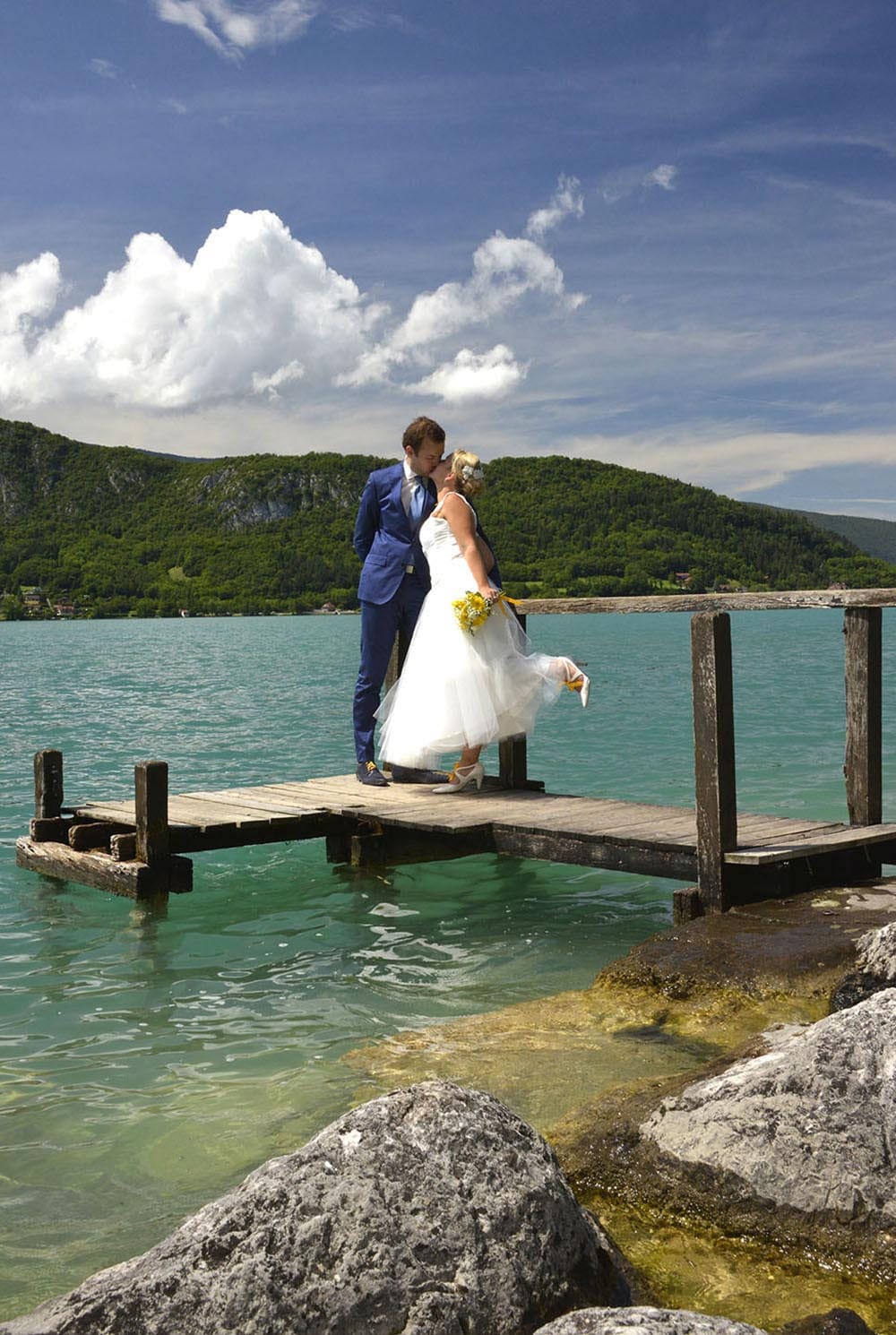 Weddings in and Around Paris 67 Wedding couple kissing on pontoon, Talloires, Lake Annecy, France